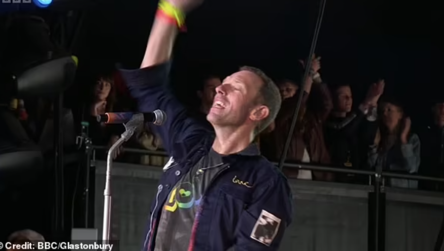 Dakota Johnson acting strange to watches Chris Martin perform Coldplay’s headline slot at Glastonbury alongside his kids Apple and Moses Martin after couple’s secret split and reconciliation